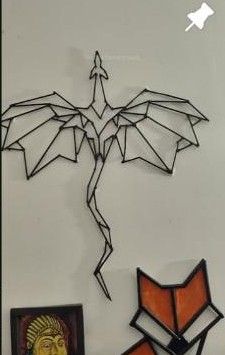 Geometric wire dragon and fox on the wall